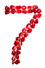 The number seven pomegranate seeds isolated on white background. For the design of education or diet