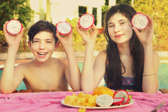 siblings teenager boy and girl with dracon cut fruit