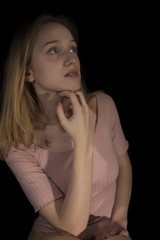 Young girl with pink body isolated on black background 