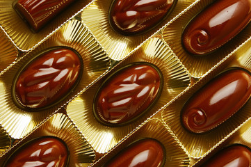 chocolate candies in a gold gift box