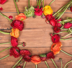 Ranunkulyus bouquet of red flowers on a wooden background