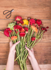 Ranunkulyus bouquet of red flowers on a wooden background