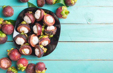Mangosteen fruit on wooden background,top view - obrazy, fototapety, plakaty