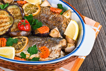 seabass fish baked with vegetables, close-up