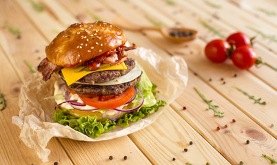 Close-up of home made burger, wooden background