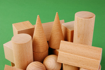 wooden geometric shapes on a green background