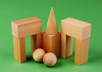wooden geometric shapes on a green background