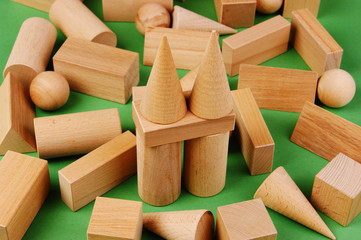 wooden geometric shapes on a green background