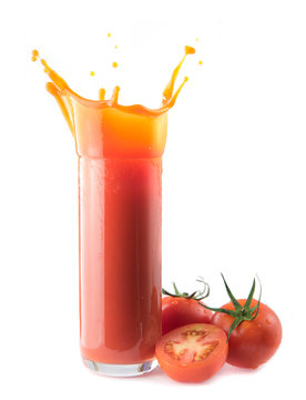 tomatoes and glass of tomato juice with splash isolated on white background