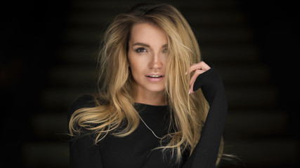 Fototapeta premium Beautiful woman posing in studio on dark background