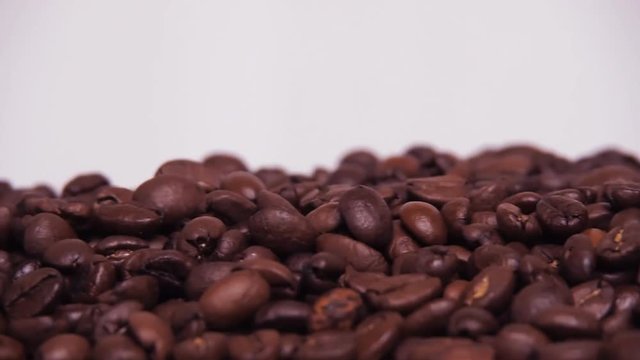 Coffee beans. Close-up. Along coffee beans. Floating over fried coffee.