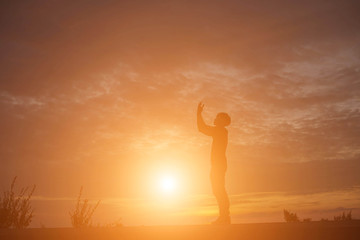 Man show hands silhouette sunset background  