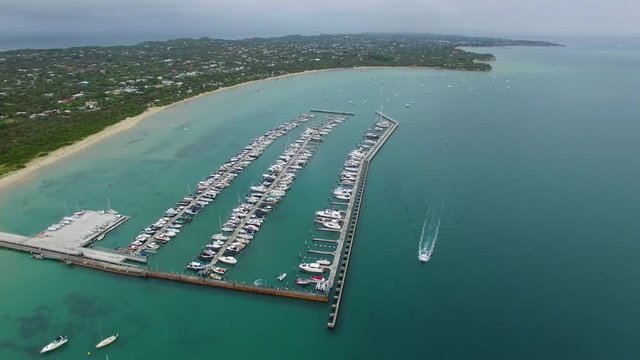 Static aerial shot of Blairgowrie Marina with sailing boat. Melbourne, Victoria, Australia