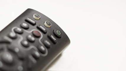 TV remote control with focus on and off button on a white background