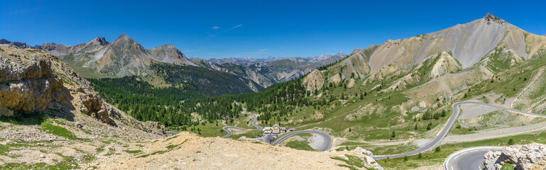 Spectacular view of the French Alps, Napoleon mountain lodge and a winding road