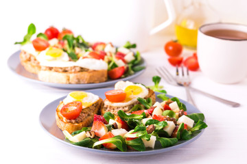 Salad with strawberry, spinach and goat cheese.  Bruschettes
