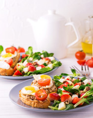 Salad with strawberry, spinach and goat cheese.  Bruschettes