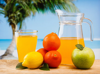 variety of fruit and juice on a wooden table in the garden