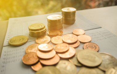pile coin money with account book finance and banking concept for background.
