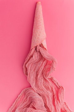 pink Ice cream cone with colorful streamers  on pink background. Flat lay