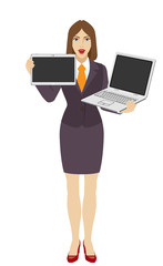 Businesswoman holding a laptop notebook and digital tablet PC