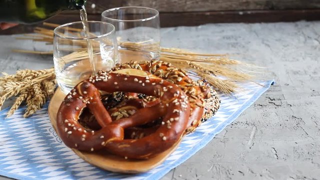 Original bavarian pretzels with beer stein on wooden board. Oktoberfest background