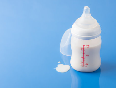 Baby milk bottle on a blue background