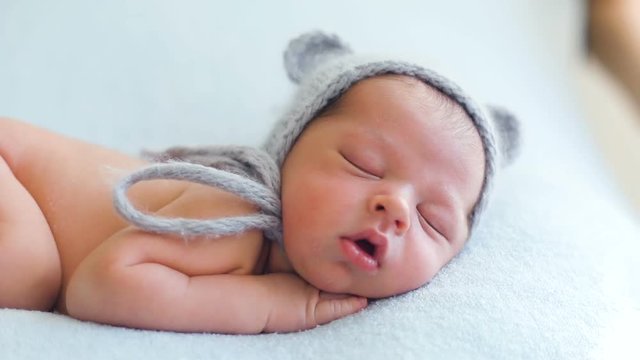 naked baby sleeping on the bed