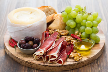 appetizer cheese with smoked meat on board