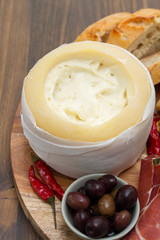 appetizer cheese with smoked meat on board