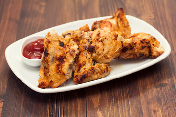 grilled chicken with sauce on dish