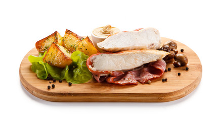 Grilled chicken fillet served on cutting board