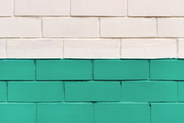 Brick wall painted in white and mint color