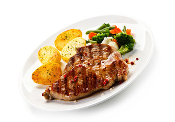Steaks, baked potatoes and vegetable salad