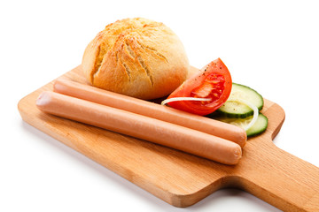 Sausages with bun on cutting board
