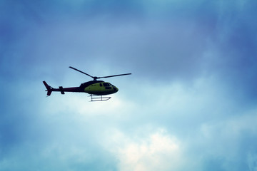 Fototapeta na wymiar Rotor helicopter flying against the blue sky background