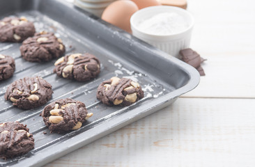 Delicious chocolate cookies with nuts on a baking tray