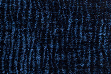 Dark blue fluffy background of soft, fleecy cloth. Texture of textile closeup