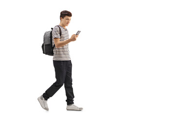 Teenage student walking and looking at a phone © Ljupco Smokovski