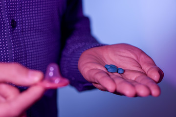 young man with blue pills and condom