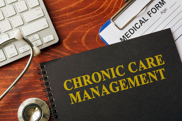Book with title chronic care management on a table. Pain management concept.