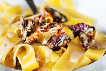 Tagliatelle with dried tomato and sauce.