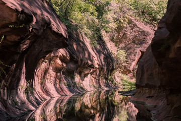 Red Rock in desert with carved  walls caused by stream over time