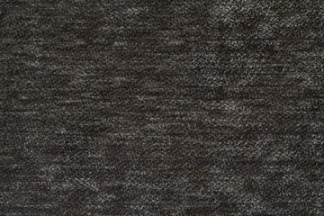 Fototapeta na wymiar Dark gray background of soft, fleecy cloth. Texture of textile closeup