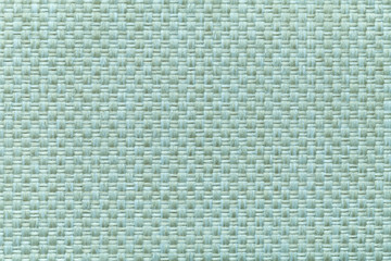 Light cyan textile background with checkered pattern, closeup. Structure of the fabric macro.