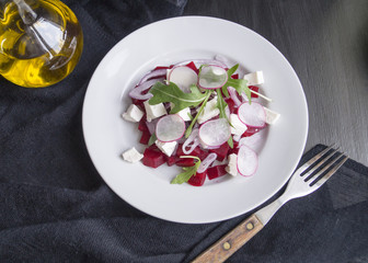 salad with beetroot and radishes on a black background