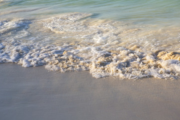 Small waves from the Caribbean ocean. Soft and smooth sand on the shore.