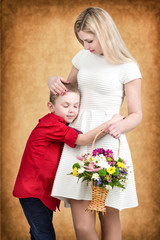  Young mother and son tenderly embrace.Spring concept of family vacation and family love. Women's day