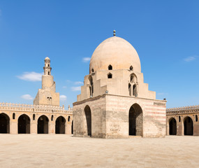 Courtyard of Ibn Tulun Mosque, Cairo, Egypt. View showing the ablution fountain and the minaret. The mosque is the largest one in Cairo, and may be the oldest mosque in the city with its original form