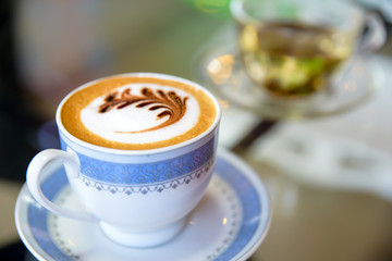 Cup of cappuccino in coffee shop  